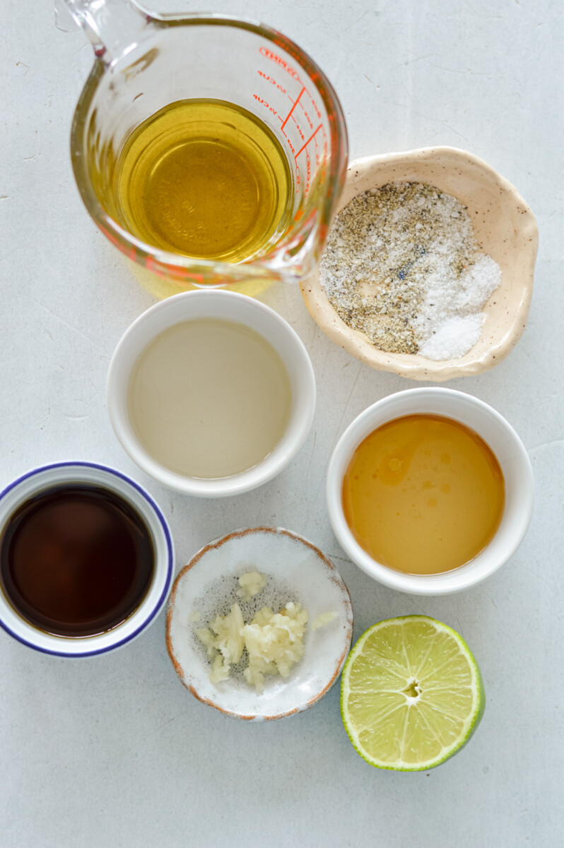 Birds eye of ingredients including soy sauce, honey, olive oil, sesame oil, rice vinegar, lime and garlic.