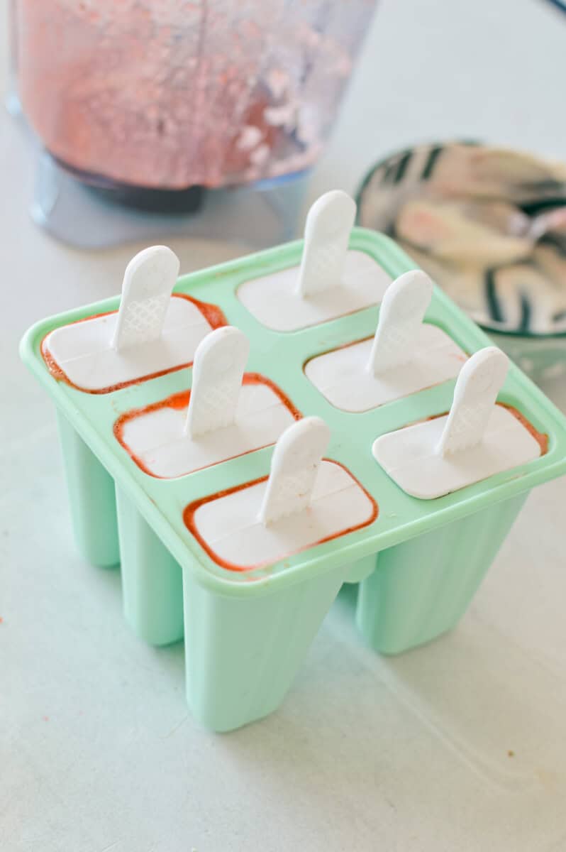Topping popsicle molds with sticks.