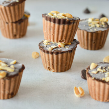 Chocolate peanut butter frozen yogurt bites stacked.