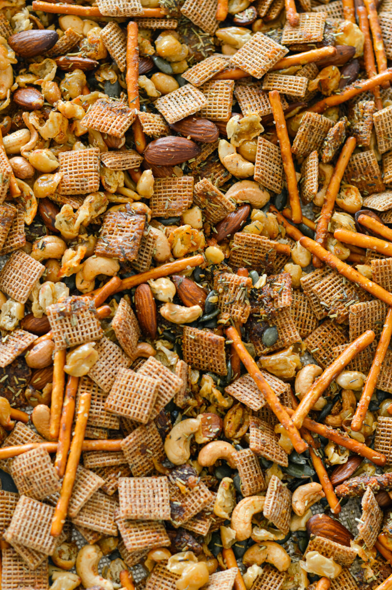 Tossing snack mix in olive oil, honey and spices mixture.