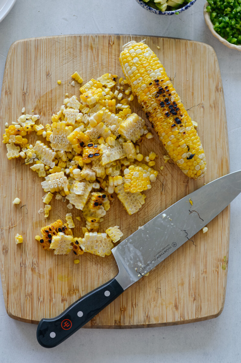 Cutting corn off the cob.