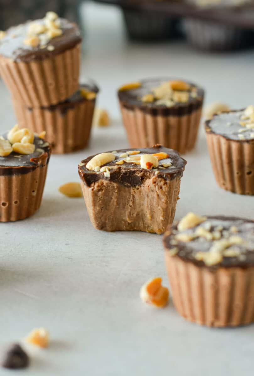 Chocolate peanut butter frozen yogurt bites with a bite out the middle.