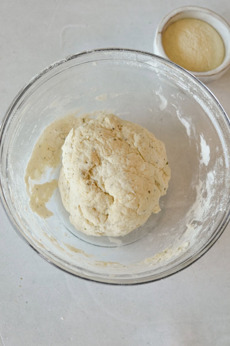 Ball of Greek yogurt pizza dough in a bowl.