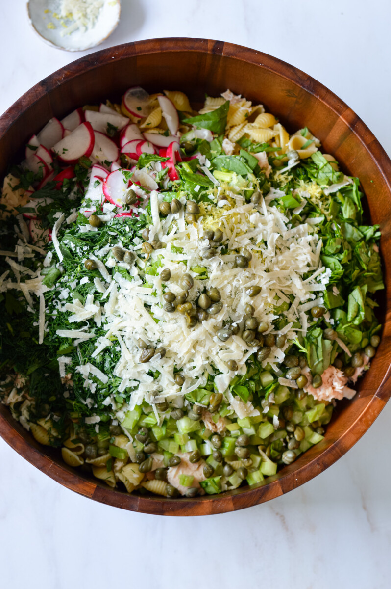 Mixing tuna pasta salad in a bowl.