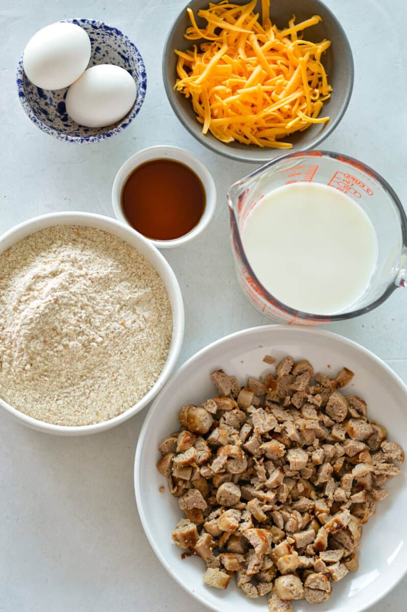 Ingredients including sausage, pancake mix, milk ,eggs, cheese and maple syrup.