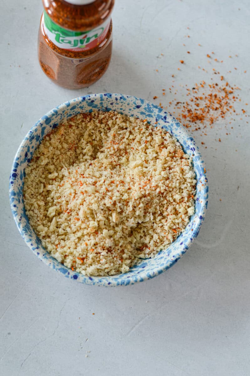Adding tajin to panko breadcrumbs.