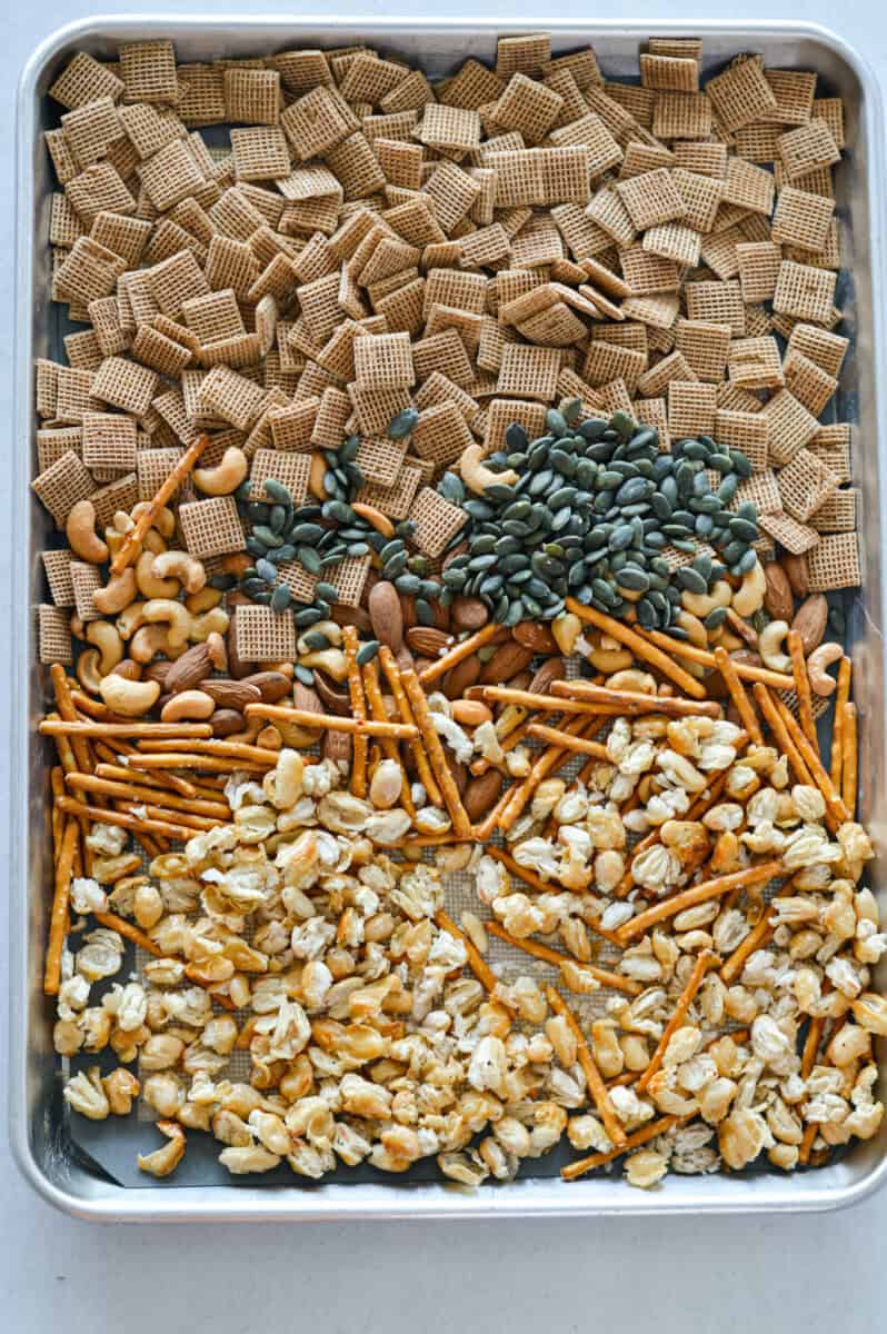 Arranging snack mix ingredients on a tray.