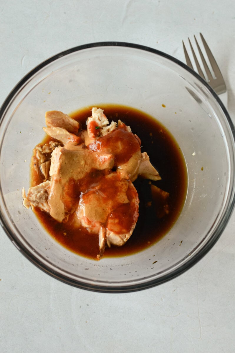 Mixing peanut butter, soy sauce, lime juice and honey in a bowl.