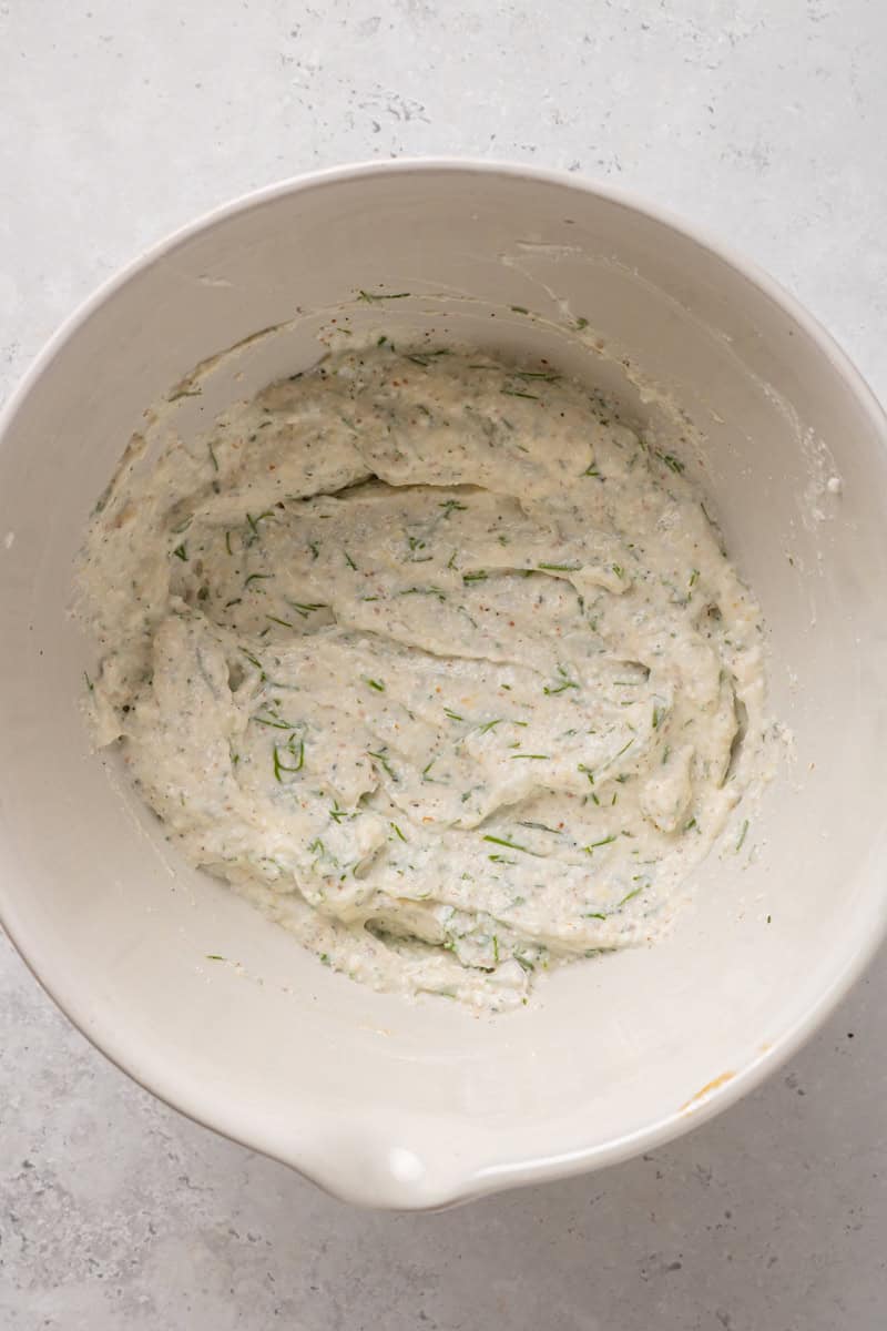 Mixing spices and herbs into cottage cheese.