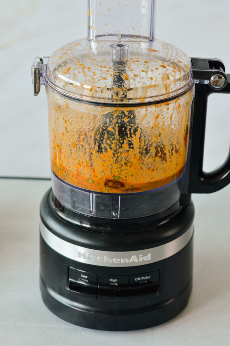 Blending chipotle sauce in a food processor.