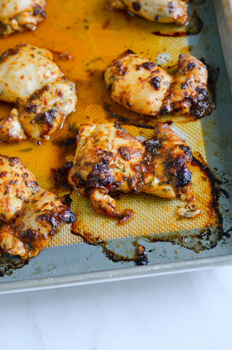 Close up of chipotle chicken thighs on a tray.