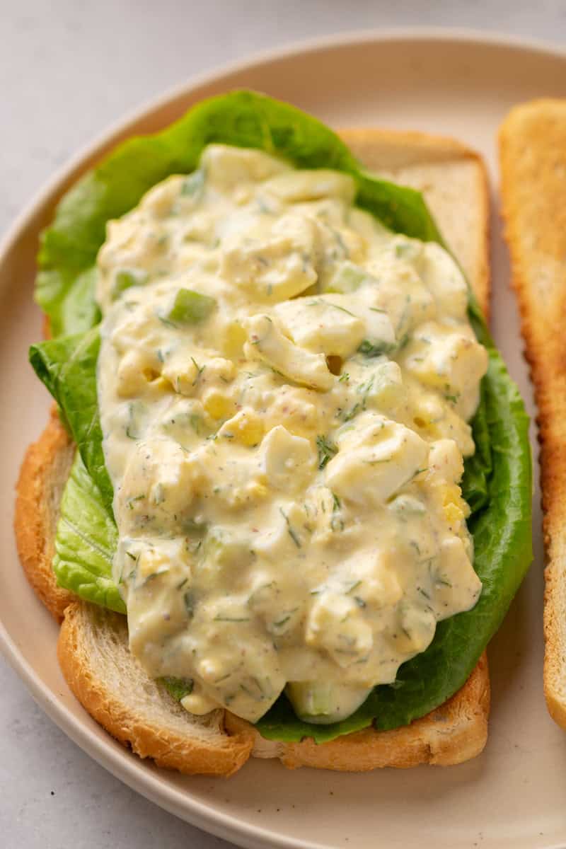 Cottage cheese egg salad served on a slice of toast with lettuce.