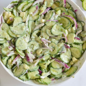 Birds eye bobwl of creamy cucumber salad.