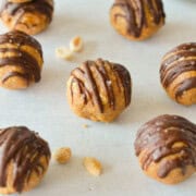 Crunchy peanut butter energy balls drizzled with chocolate.