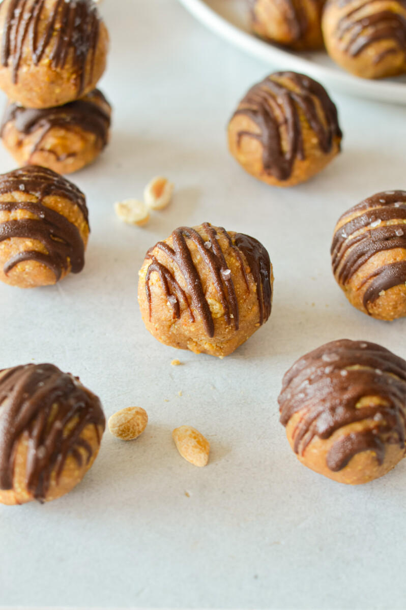 Crunchy peanut butter energy balls drizzled with chocolate.