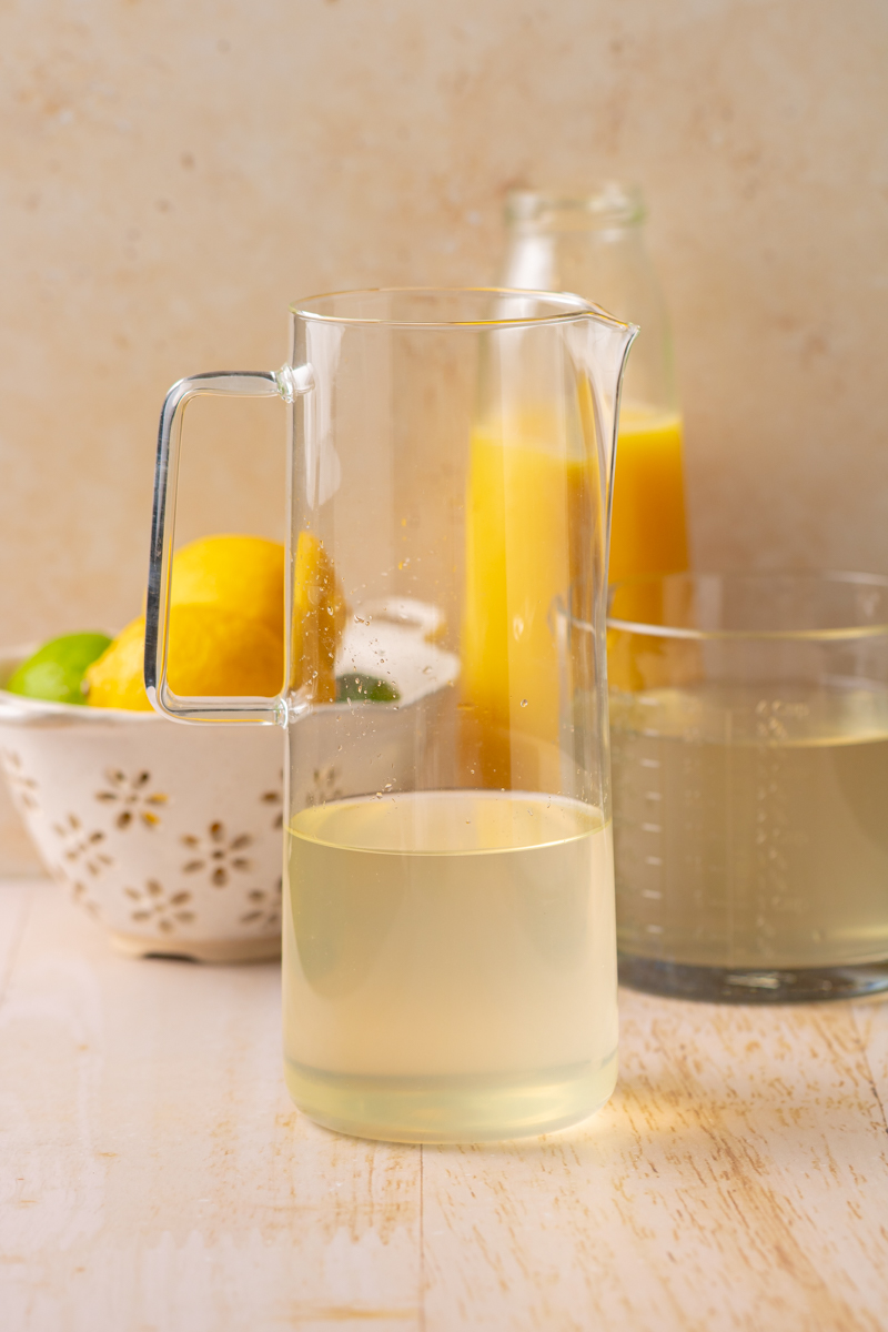 Making homemade electrolyte drink recipe in a pitcher.