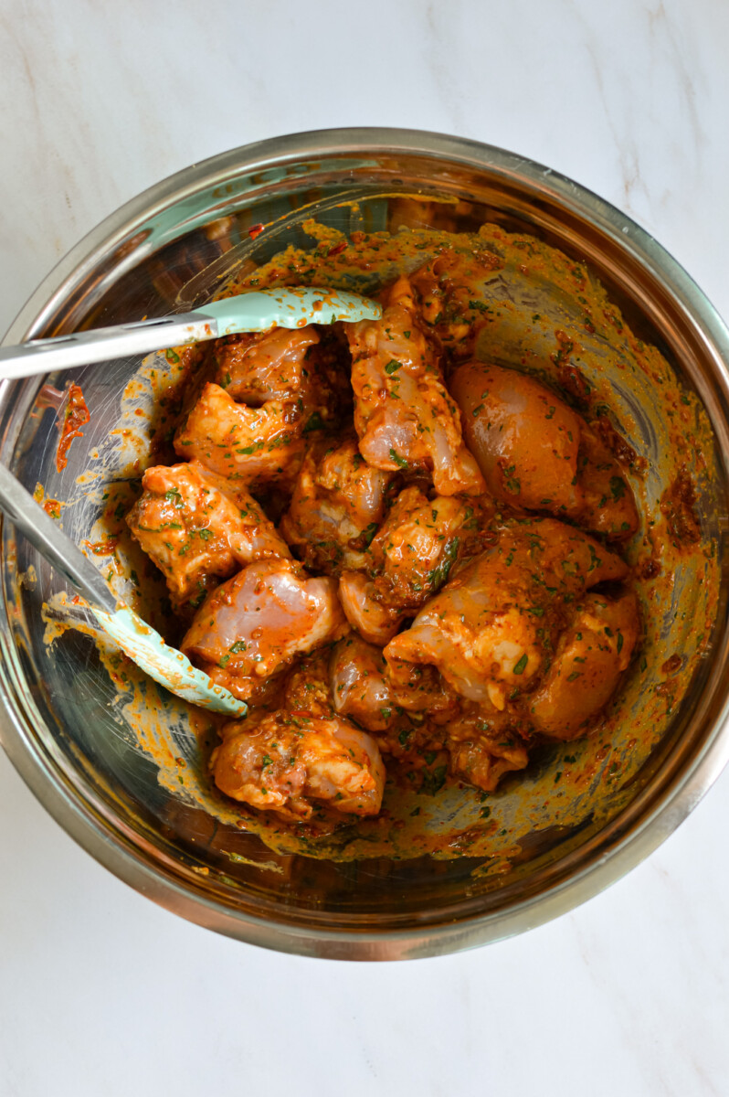 Marinating chipotle chicken thighs in a bowl.