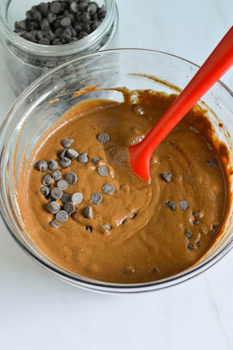 Mixing a bowl of chocolate and zucchini brownie batter.