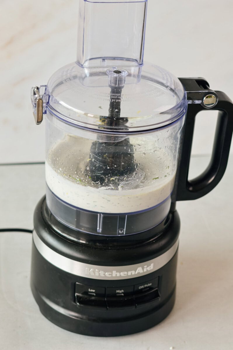 Whipping ricotta cheese in a food processor.