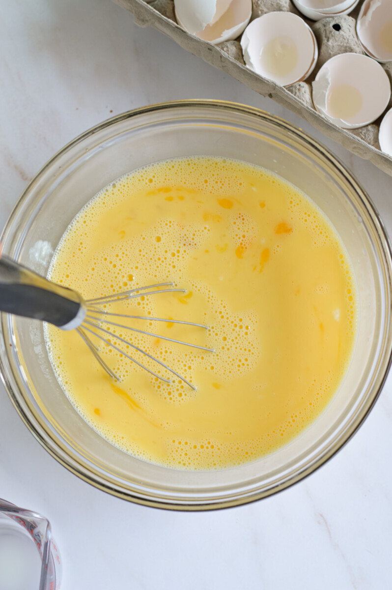 Whisking eggs, milk and cottage cheese.